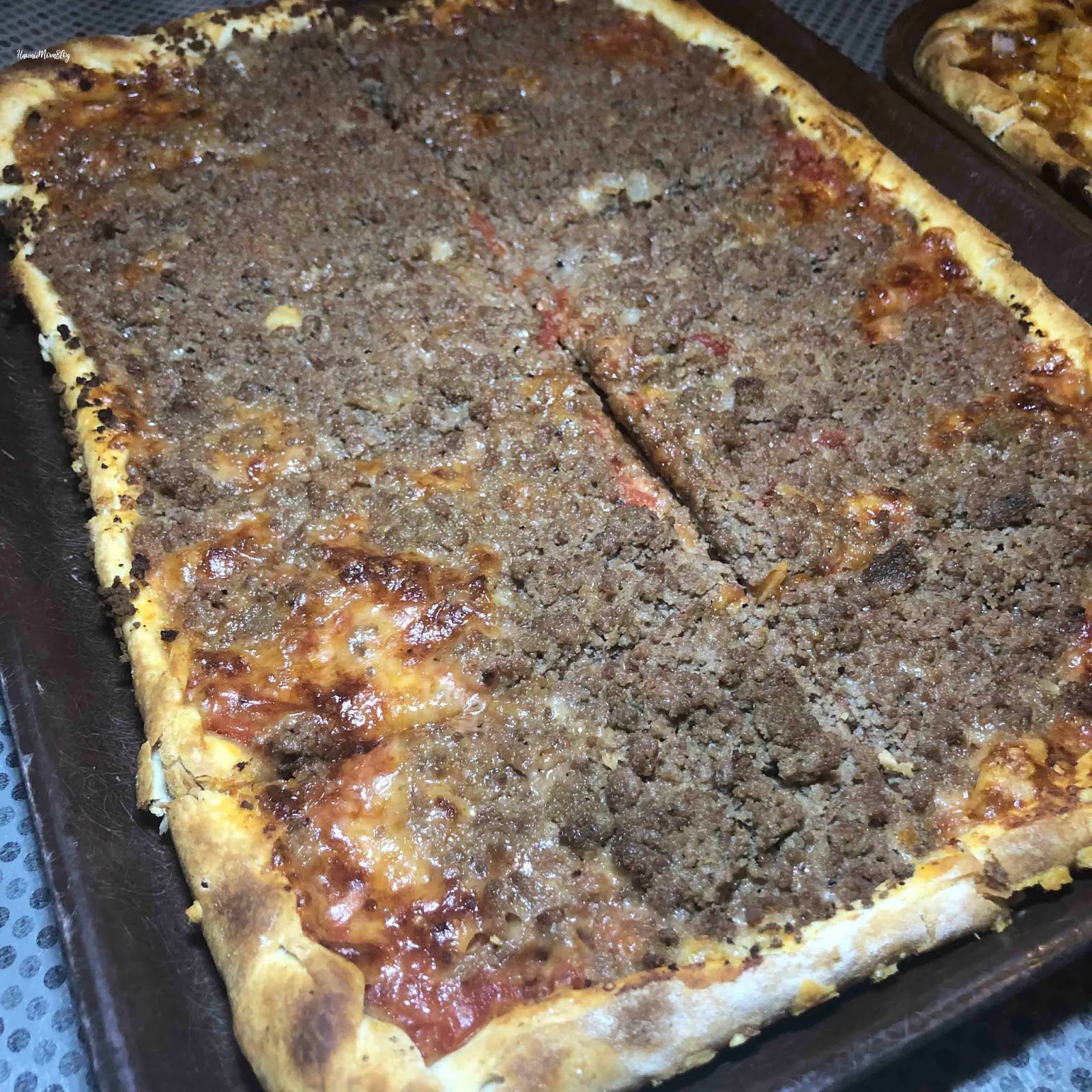 La Casa Pizzaria signature dishes Hamburger Pizza, Cheese Pizza with Italian Sausage, Onion Rings
